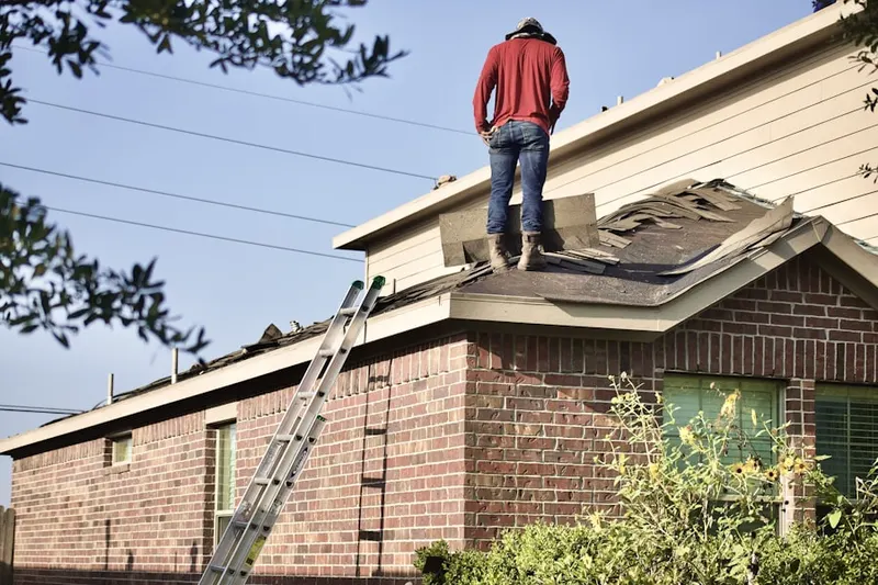 Professional roofer working on a residential roof in Abington